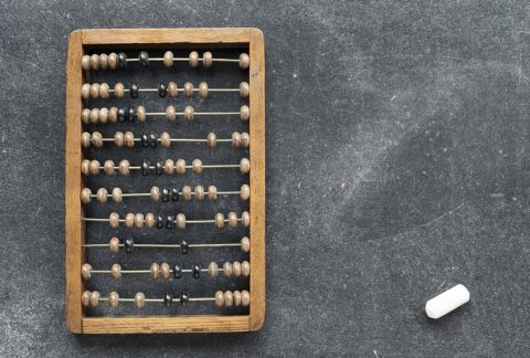 vintage wooden abacus with chalk piece on the blackboard